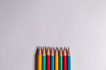 Many colored pencils on a white background can be used to make backgrounds. Education