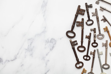 Vintage old fashioned keys on a marble background with copy space
