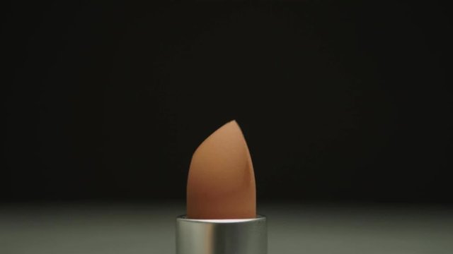 Seamless stop motion lipstick pattern come up. Macro shoot lip stick, close up makeup and beauty opening and closing. UHD 4K video.