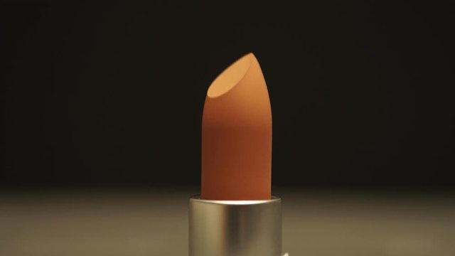 Seamless stop motion lipstick pattern come up. Macro shoot lip stick, close up makeup and beauty opening and closing. UHD 4K video.