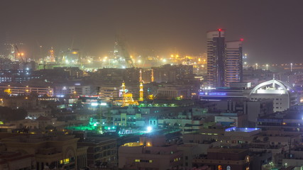 Aerial view over Port Rashid illuminated at night during sand storm timelapse in Dubai, United Arab Emirates