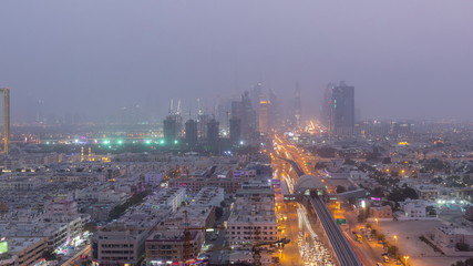 Naklejka na ściany i meble Dubai cityscape during sand storm day to night timelapse