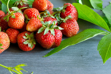 Fresh ripe red strawberries on gray table. Diet, healthy, vegan.