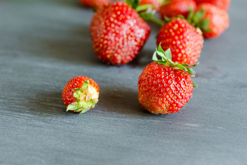 Fresh ripe red strawberries on gray table. Diet, healthy, vegan.