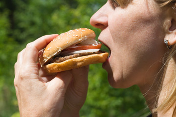 Woman eating hamburger