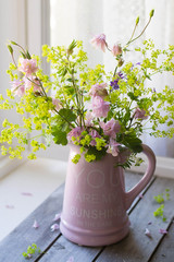 Garden flowers bouquet on wooden background