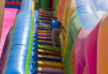 children play on an inflatable slide