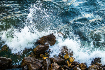 Waves hitting to the rock on a sea coast at evening