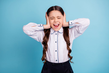 Close up photo of school lady eyes closed hands hide ears noisy classroom classmates wear white shirt isolated blue background