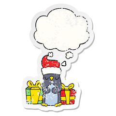 cute christmas penguin and thought bubble as a distressed worn sticker