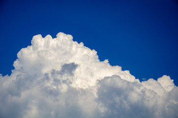 Naklejka na ściany i meble Blue sky background with white cumulus clouds
