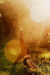 Plus size girl doing yoga in nature.