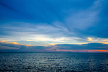 Colorful sunset with dramatic of purple , magenta and orange cloudy sky in evening over an ocean.