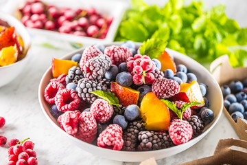 Frozen fruits blueberries blackberry raspberry red currant peach and herbs melissa