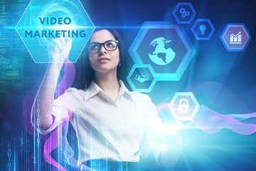 The concept of business, technology, the Internet and the network. A young entrepreneur working on a virtual screen of the future and sees the inscription: Video marketing