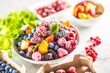 Frozen fruits blueberries blackberry raspberry red currant peach and herbs melissa