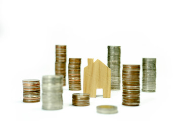 House model on coin pile saving for concept with isolated on white background.Concept for property ladder, mortgage and real estate investment. home loan and Interest from the bank.