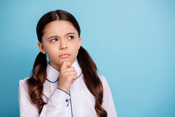 Close up photo of thoughtful kid have dilemma difficult test touch chin wear white blouse isolated over blue background