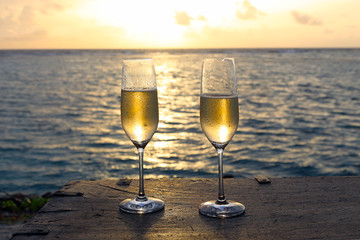 two glasses of champagne on the beach