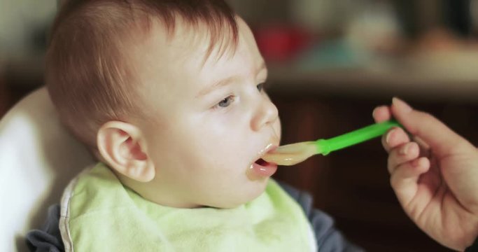 Baby boy eats cabbage puree