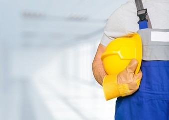 Construction worker with tools in empty building