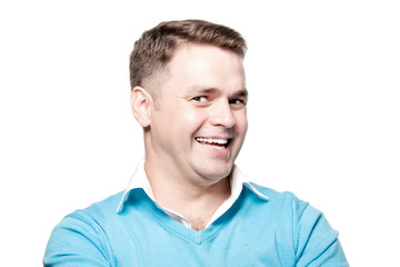 Fototapeta premium Laughing young man on a white background in the studio.