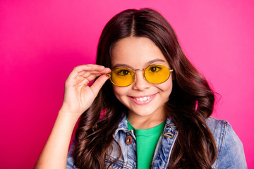 Close up photo beautiful little age she her girl hold arm amazing yellow sun specs positive optimistic stunning funky wear casual jeans denim jacket isolated pink bright vibrant vivid background