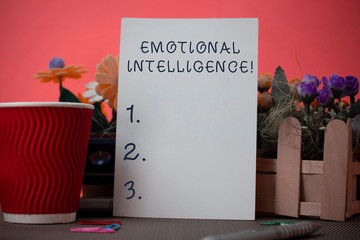 Handwriting text writing Emotional Intelligence. Conceptual photo Self and Social Awareness Handle relationships well Flowers and stationary plus plain sheet with paper big cup above a table