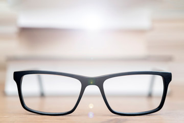 Glasses on background of books. Symbol of knowledge, science, study, wisdom.