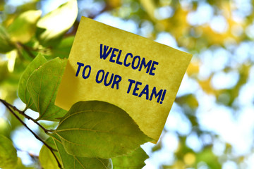 Word writing text Welcome To Our Team. Business photo showcasing introducing another demonstrating to your team mates Piece of square paper use to give notation on tree leaf under sunny day