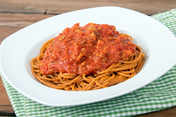 plain cooked spaghetti pasta no topping over a wood table