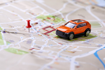 travel concept - small toy car on the map - Powered by Adobe