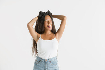 Fototapeta premium Beautiful female half-length portrait isolated on white studio background. Young emotional african-american woman with long hair. Facial expression, human emotions concept. Feels crazy happy, jumping.