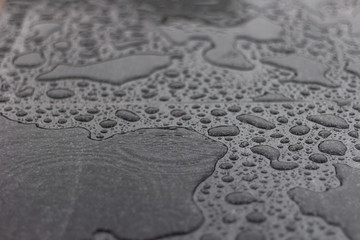 Fototapeta na wymiar water rain black marble drops design macro