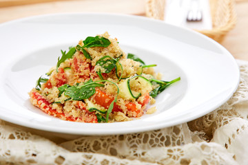 An easy, zesty summer salad with a Mediterranean flair featuring Israeli couscous and chopped summer vegetables