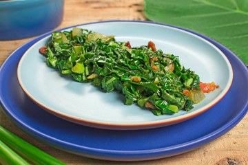 Braised exotic edible plant recipe (Xanthosoma sagittifolium) called taioba in Brazil close