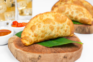 Traditional Brazilian fried pastry called pastel stuffed with Exotic edible plant called taioba