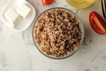 Buckwheat. Porridge cereals in a glass plate on a bright table. breakfast, healthy food. top view