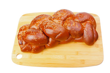 Sweet wicker challah for Shabbat on cutting board