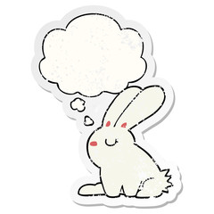 cartoon rabbit and thought bubble as a distressed worn sticker