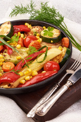 Grilled vegetables in a cast iron grilling pan on a rustic background