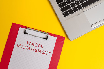 Conceptual hand writing showing Waste Management. Concept meaning actions required analysisage rubbish inception to final disposal Part view metallic laptop clipboard paper sheet colored background