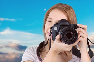 Woman-photographer takes a black digital camera on abstract background