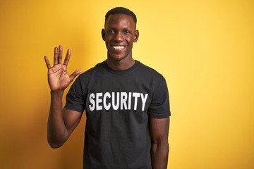 African american safeguard man wearing security uniform over isolated yellow background showing and...