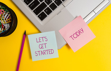 Text sign showing Let S Is Get Started. Business photo text to begin doing or working on something you had started Trendy metallic laptop sticky notes clips container pencil colored background