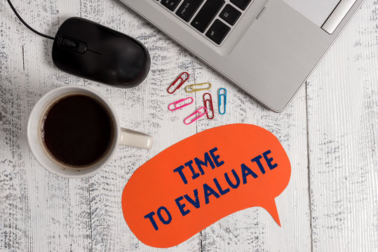 Conceptual hand writing showing Time To Evaluate. Concept meaning judge something with respect to its worth or significance Metallic laptop speech bubble coffee cup on vintage table