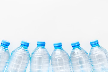 Plastic bottles with pure water on white background top view space for text