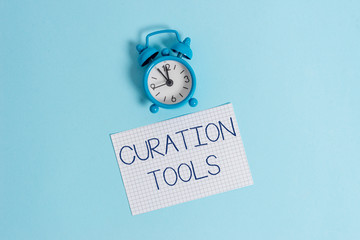Word writing text Curation Tools. Business photo showcasing Software used in gathering information relevant to a topic Vintage alarm clock wakeup squared blank paper sheet colored background