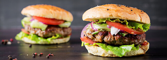 Big sandwich - hamburger burger with beef,  tomato,  red onion and lettuce.