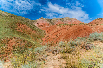 View of the bright red sandy-clayey slopes of the mountain Big Bogdo.